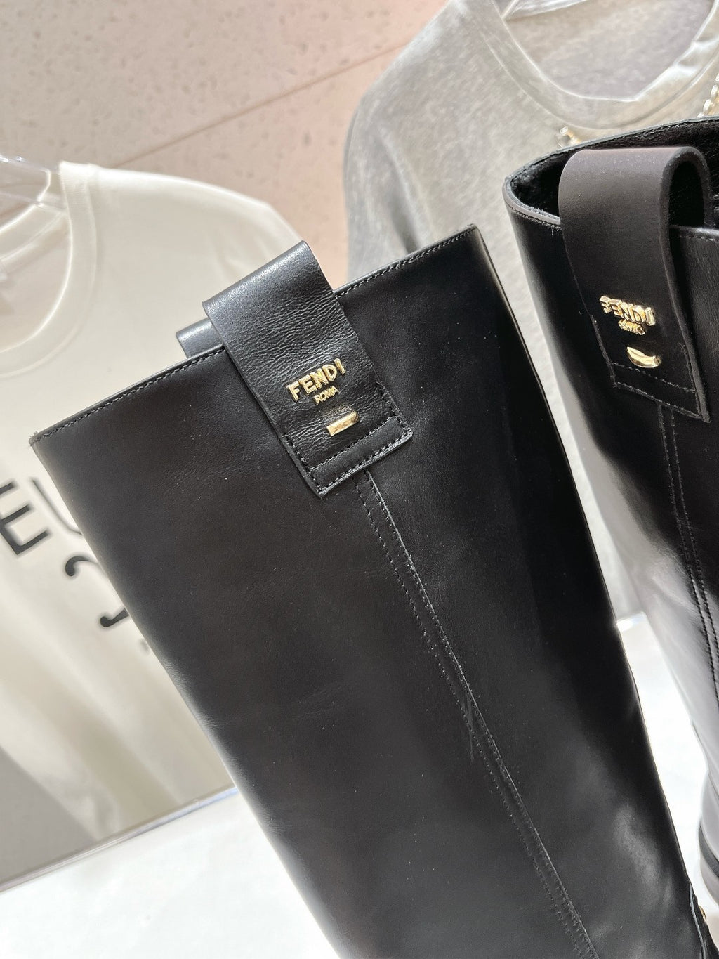 Black leather knee-high boot upper with FENDI logo patch and side pull opening