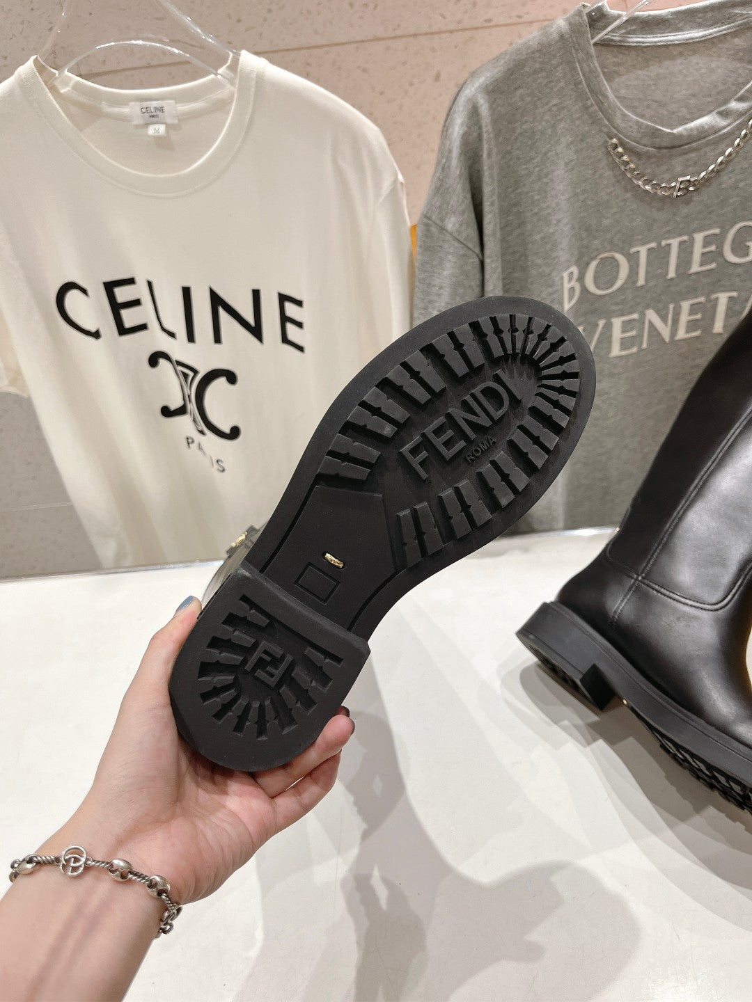 Black boot outsole with FENDI text and deep tread pattern