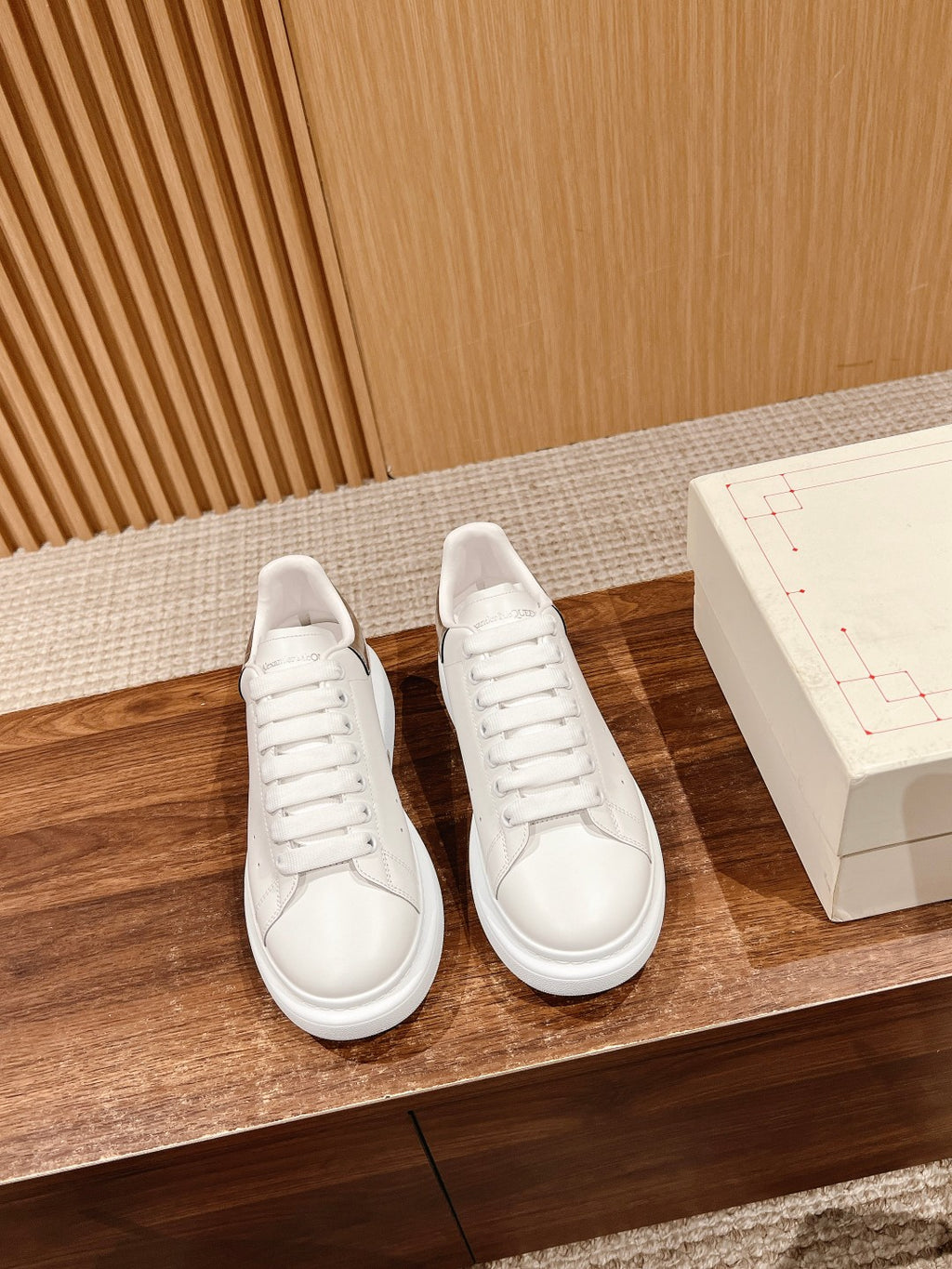 Pair of white low-top lace-up sneakers with smooth leather upper