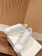 White leather lace-up sneakers with logo patch and cupsole sole
