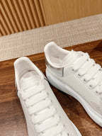 White leather lace-up sneakers side view with padded collars