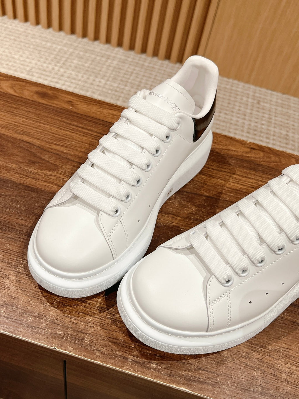 White low-top sneakers with lace-up vamp and smooth side panels