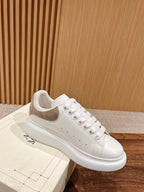 White leather sneaker with beige suede trim and lace-up front