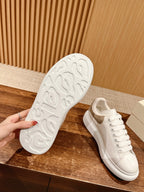 White sneaker outsole with textured tread and front lace-up shoe