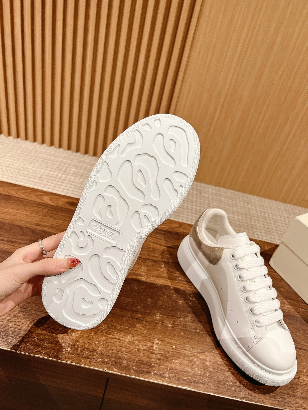White sneaker outsole with textured tread and front lace-up shoe