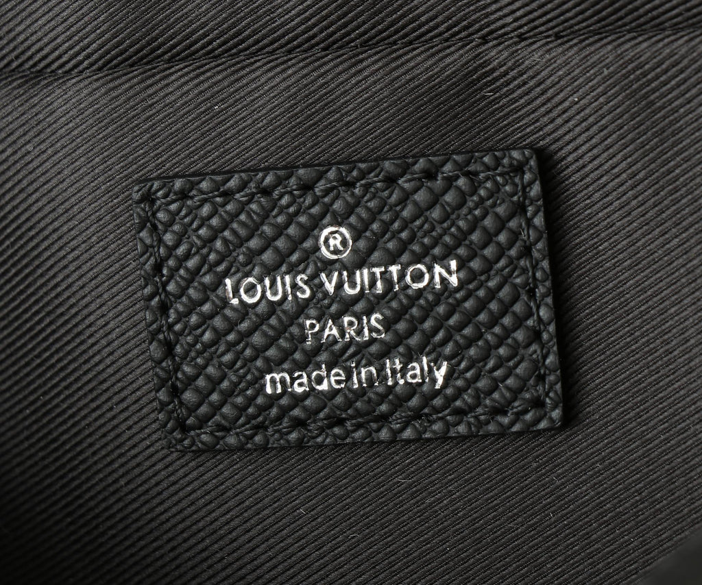 Black leather bag interior label reading 'LOUIS VUITTON PARIS made in italy'.