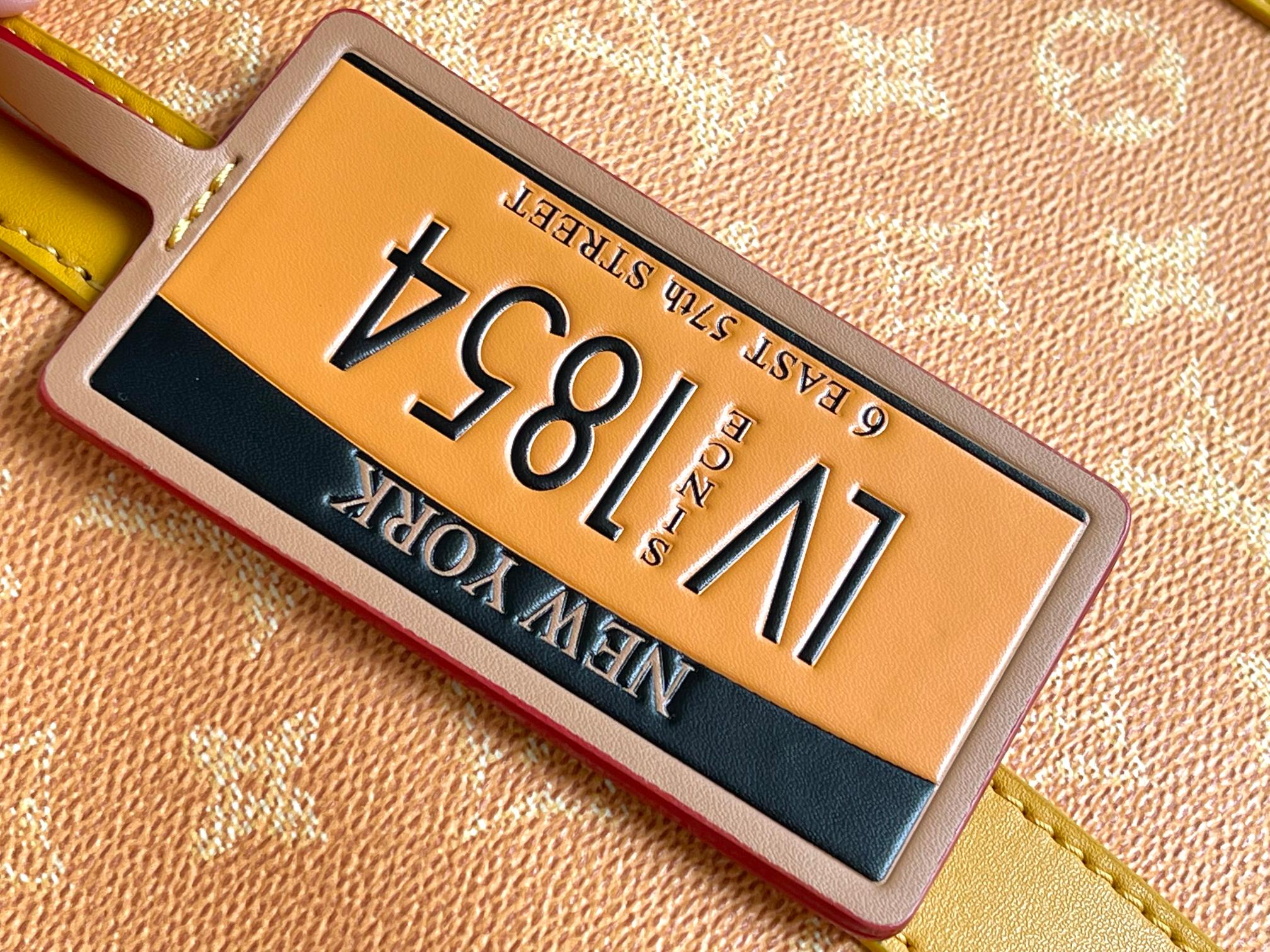 Louis Vuitton luggage tag on monogram canvas with gold and dark backing