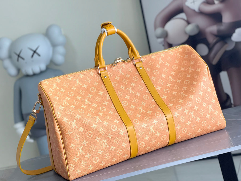Monogram duffel bag with long strap and yellow trim, side angle