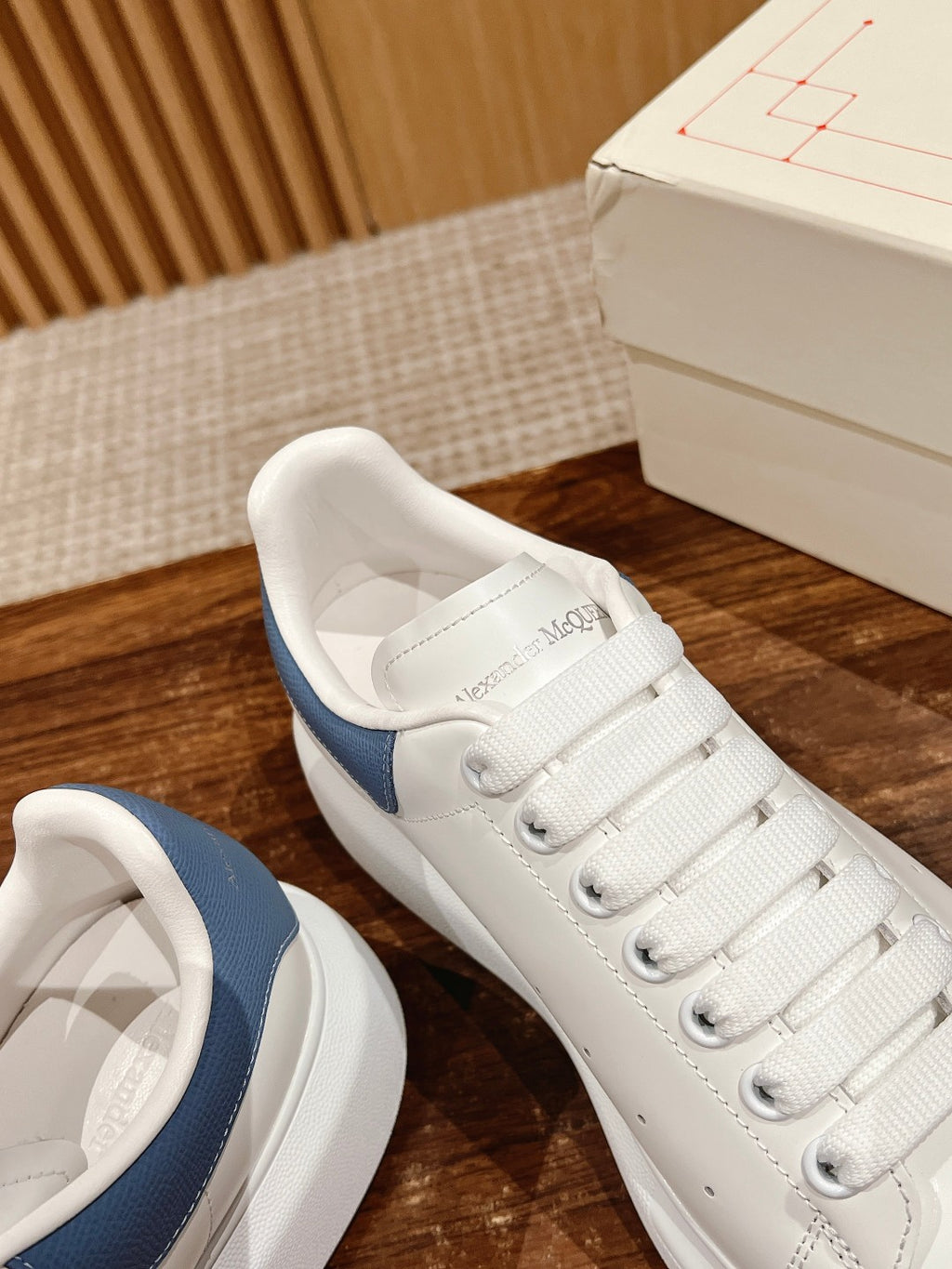 Alexander McQueen sneakers with blue heel and logo on insole, open angle