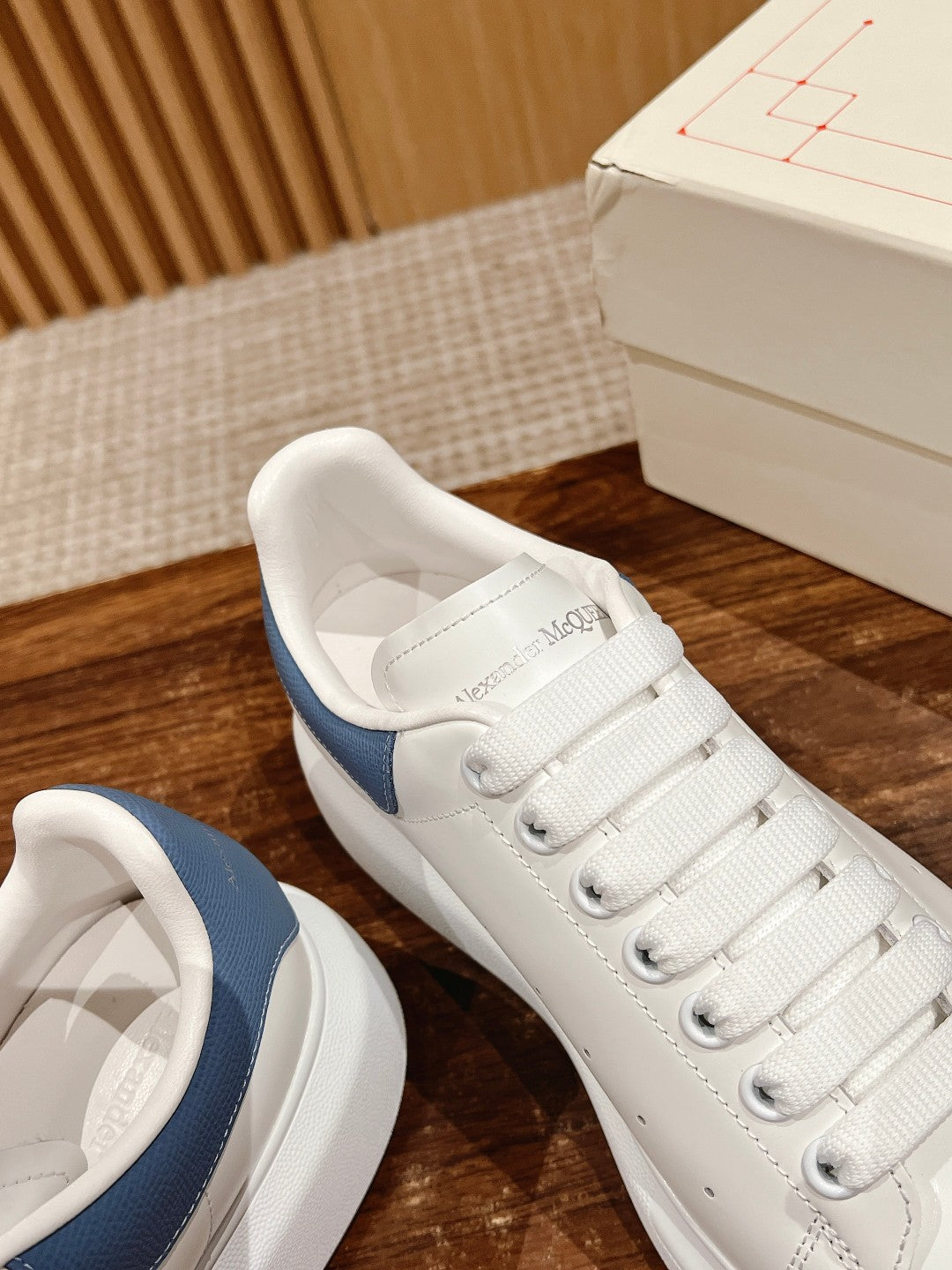 Alexander McQueen sneakers with blue heel and logo on insole, open angle