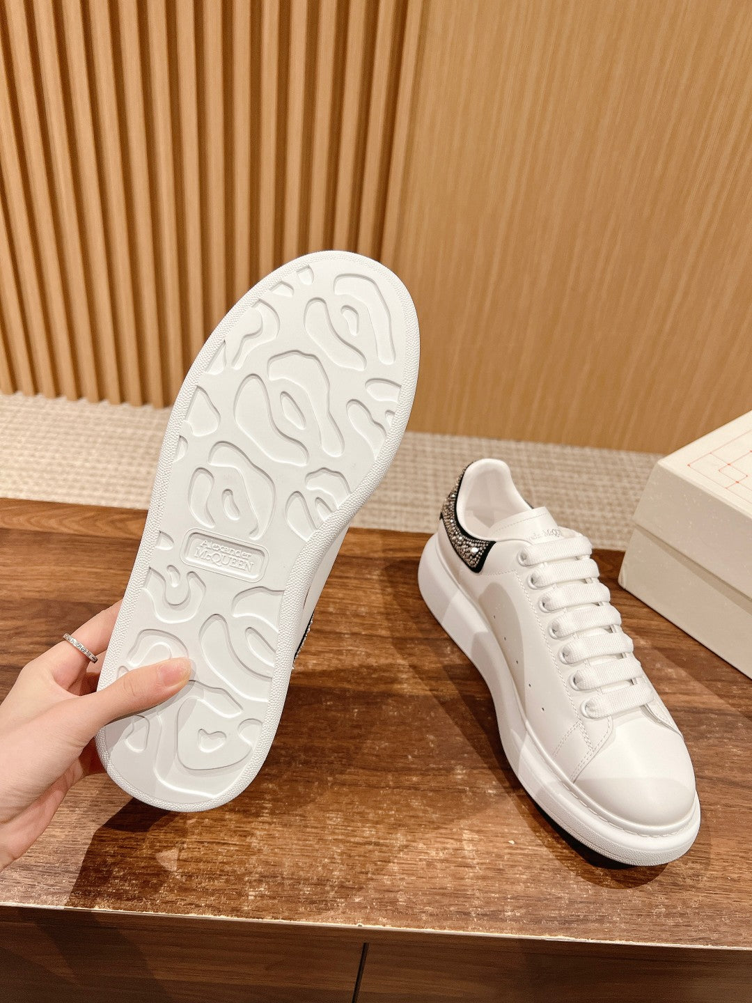 White sneaker outsoles with textured tread; pair shown with heels