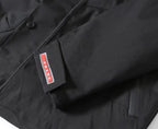 Prada label on dark jacket, red-white logo tag detail