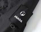 Prada PRADA logo patch with circular emblem on dark jacket sleeve