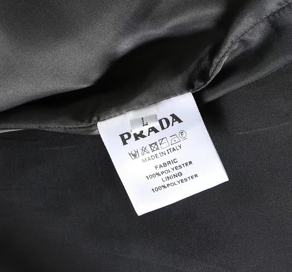 Black coat with white care label reading Prada and Made in Italy