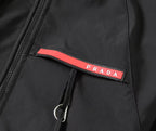 Black Prada jacket logo patch with red stripe on chest pocket flap