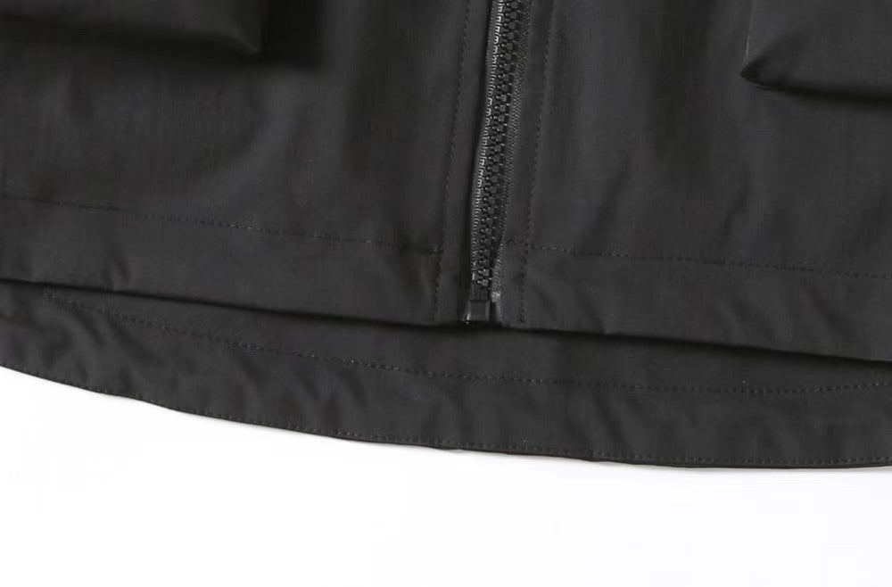 Black Prada rain jacket hem with zipper seam and snap closure