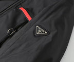 Black Prada jacket detail with triangular logo badge and red trim