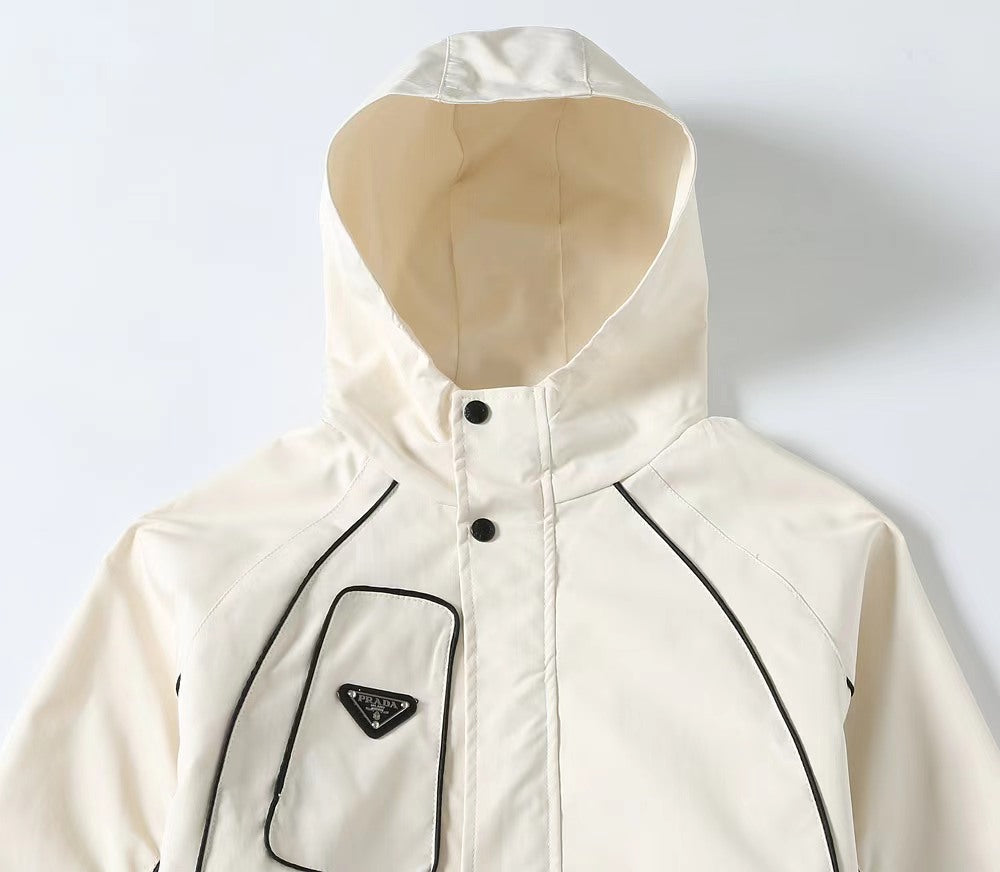 White hooded jacket with high collar and black-outlined chest pocket design