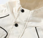 White hooded jacket collar detail with two black snap buttons and black trim