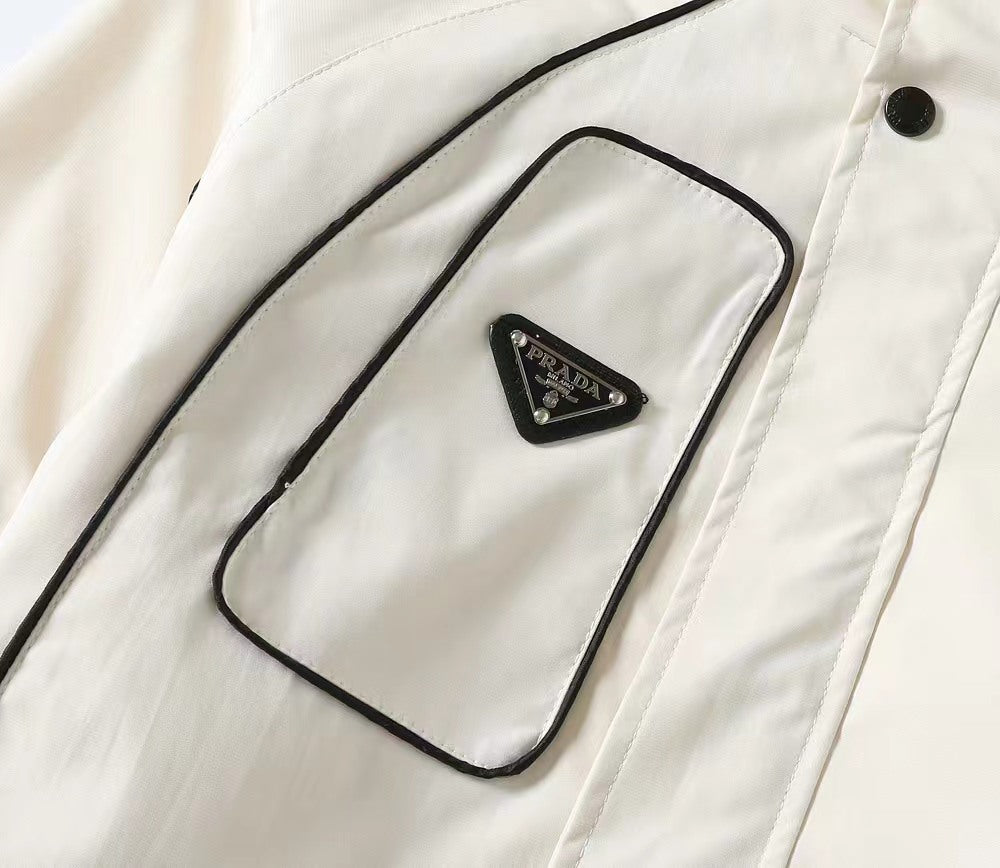 White hooded jacket chest pocket with small triangular PRADA logo patch