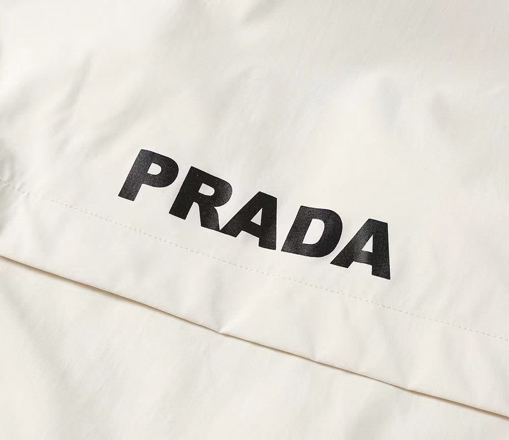 White jacket fabric with large PRADA lettering across the front