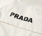 White jacket fabric with large PRADA lettering across the front