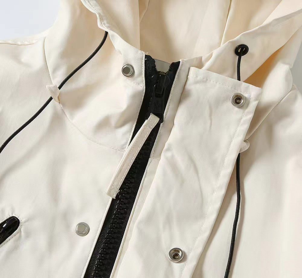 Moncler jacket front detail with zipper, snap buttons, and drawstring cords