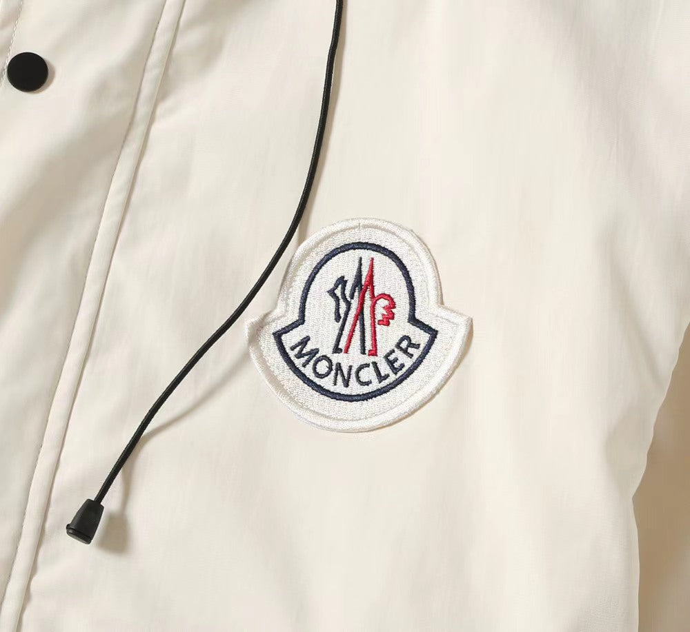 Moncler logo patch on dark hooded jacket with drawstring cords