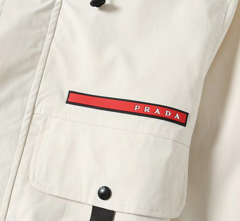 Prada chest label on white long jacket with red stripe and snap button detail
