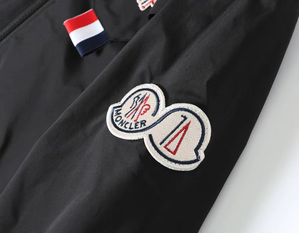 Moncler jacket close-up: heart logo patch with red-white-blue stripe tab