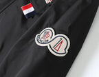 Moncler jacket close-up: heart logo patch with red-white-blue stripe tab