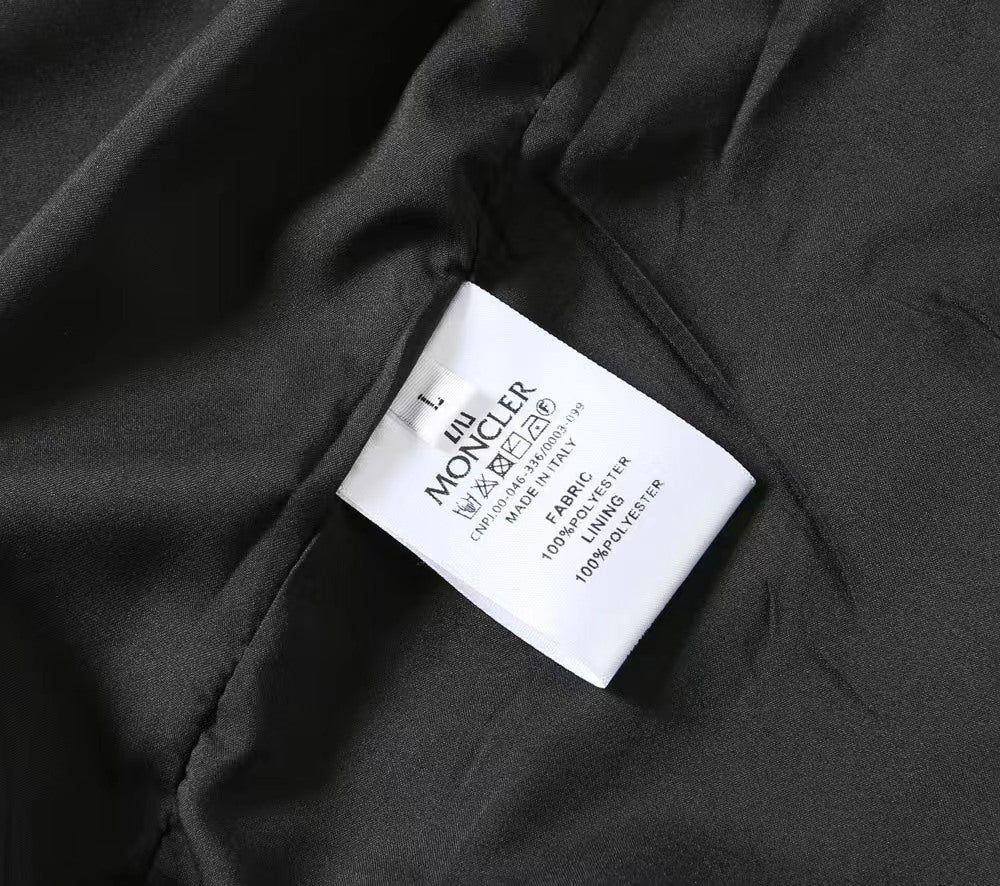 Moncler black jacket fabric with white care label tag