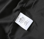 Moncler size label on black jacket fabric near seam