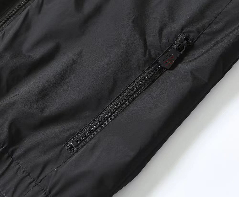 Moncler black jacket close-up, metal zipper and pull on front