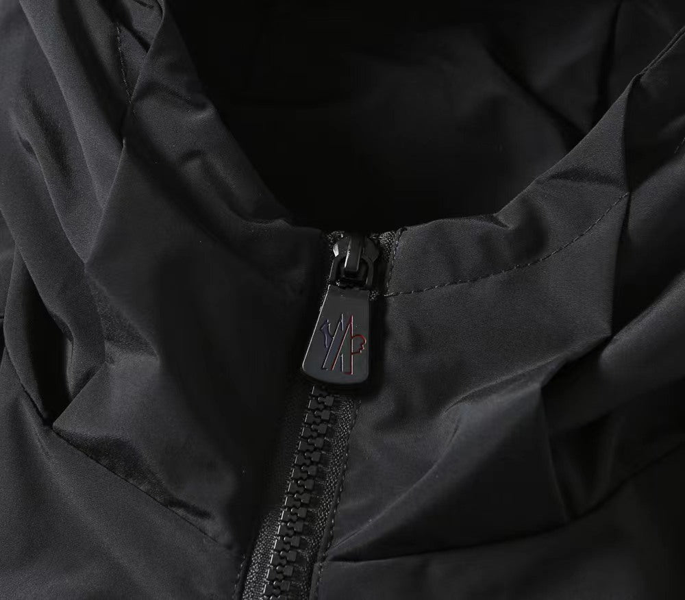 Moncler black jacket detail, front zipper and branded zipper pull