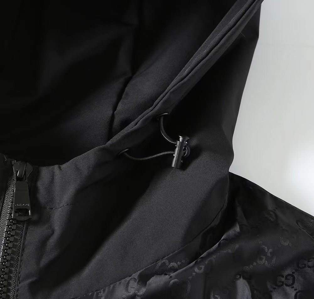Gucci hooded jacket close-up of drawcord and zip placket in dark fabric