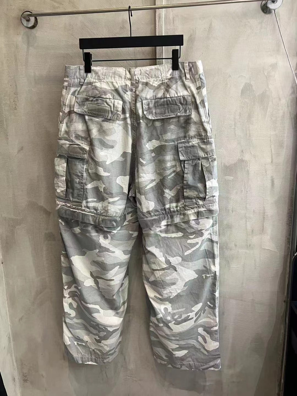 Balenciaga camouflage cargo pants, light gray and white, close front view with patch pockets