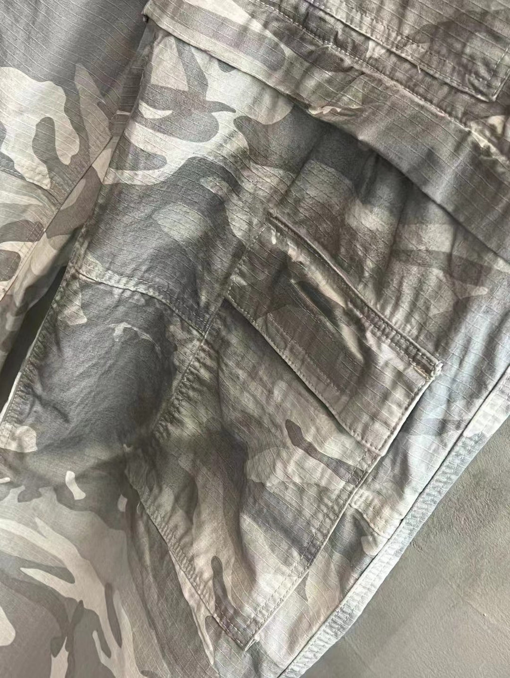 Balenciaga camouflage cargo pants, light gray and white, leg with cargo pocket flap detail