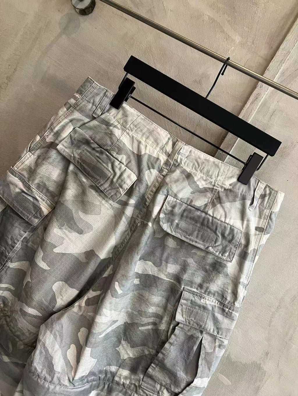 Balenciaga camouflage cargo pants, light gray and white, side view with multiple patch pockets