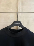 Black crew-neck T-shirt with neckline seam and hanging neck label