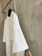Balenciaga short-sleeve T-shirt, white, side view with partial yellow smiley graphic