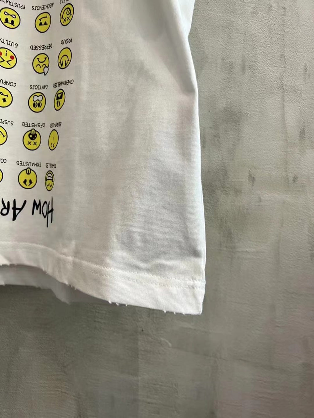 Balenciaga short-sleeve T-shirt, white, lower front close-up with yellow smiley print