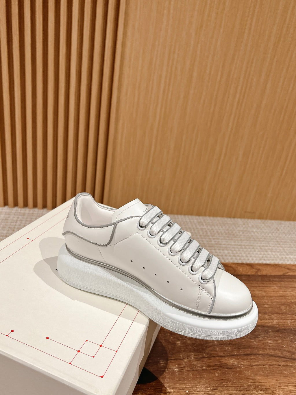 White Alexander McQueen leather sneakers with gray side stripe and lace-up