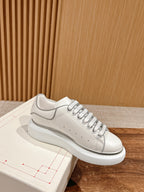 White Alexander McQueen leather sneakers with gray side stripe and lace-up