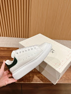 Alexander McQueen leather sneakers, white with green heel panel and perforated toe