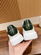 Alexander McQueen leather sneakers, white back view with dark green heel panels