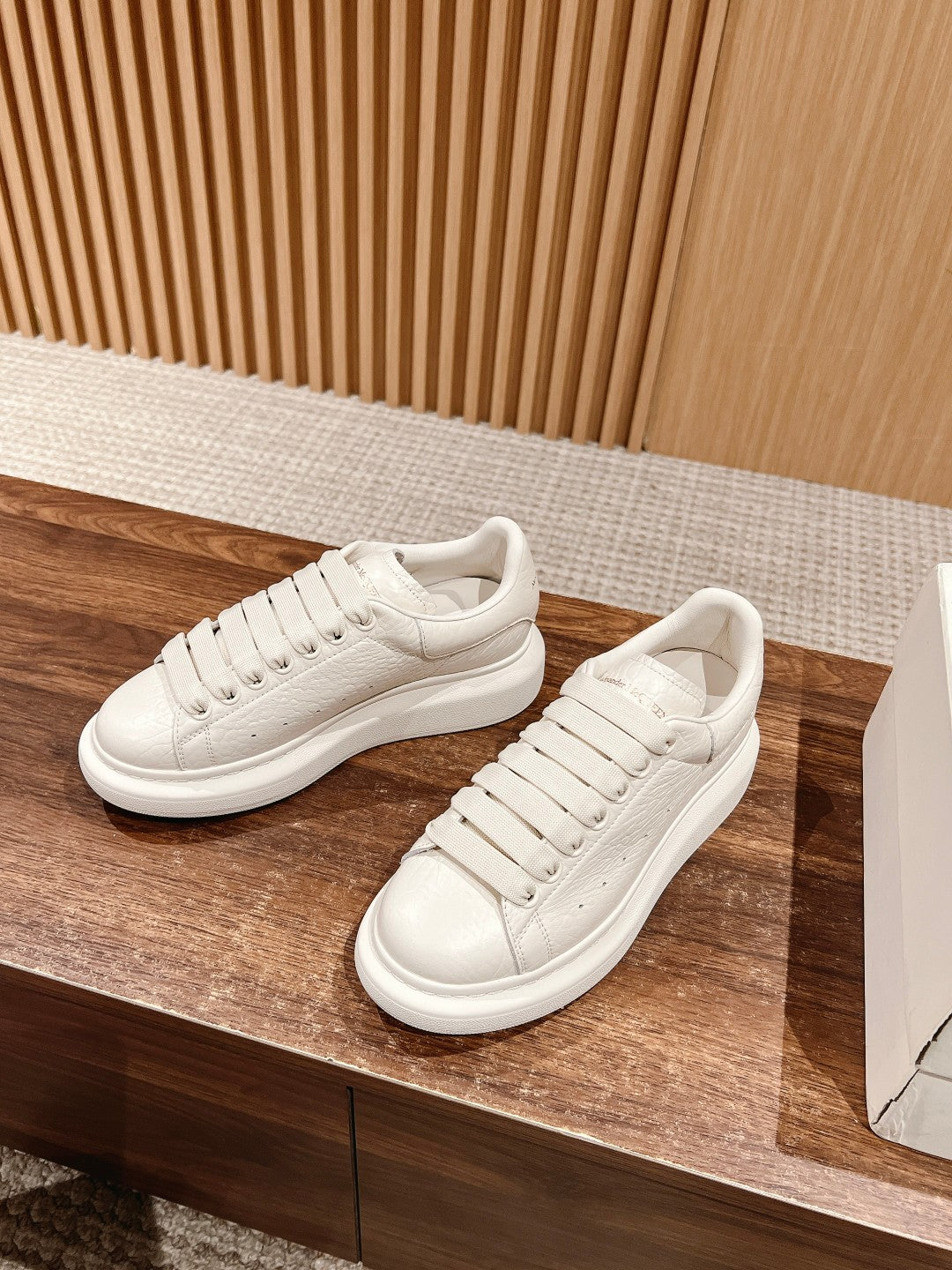 White leather lace-up sneakers with perforated toe and side stitching