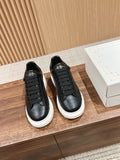 Pair of black leather lace-up sneakers with white rubber platform soles