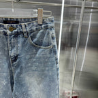 Louis Vuitton blue denim pants side view, monogram pattern, front pockets, belt loops