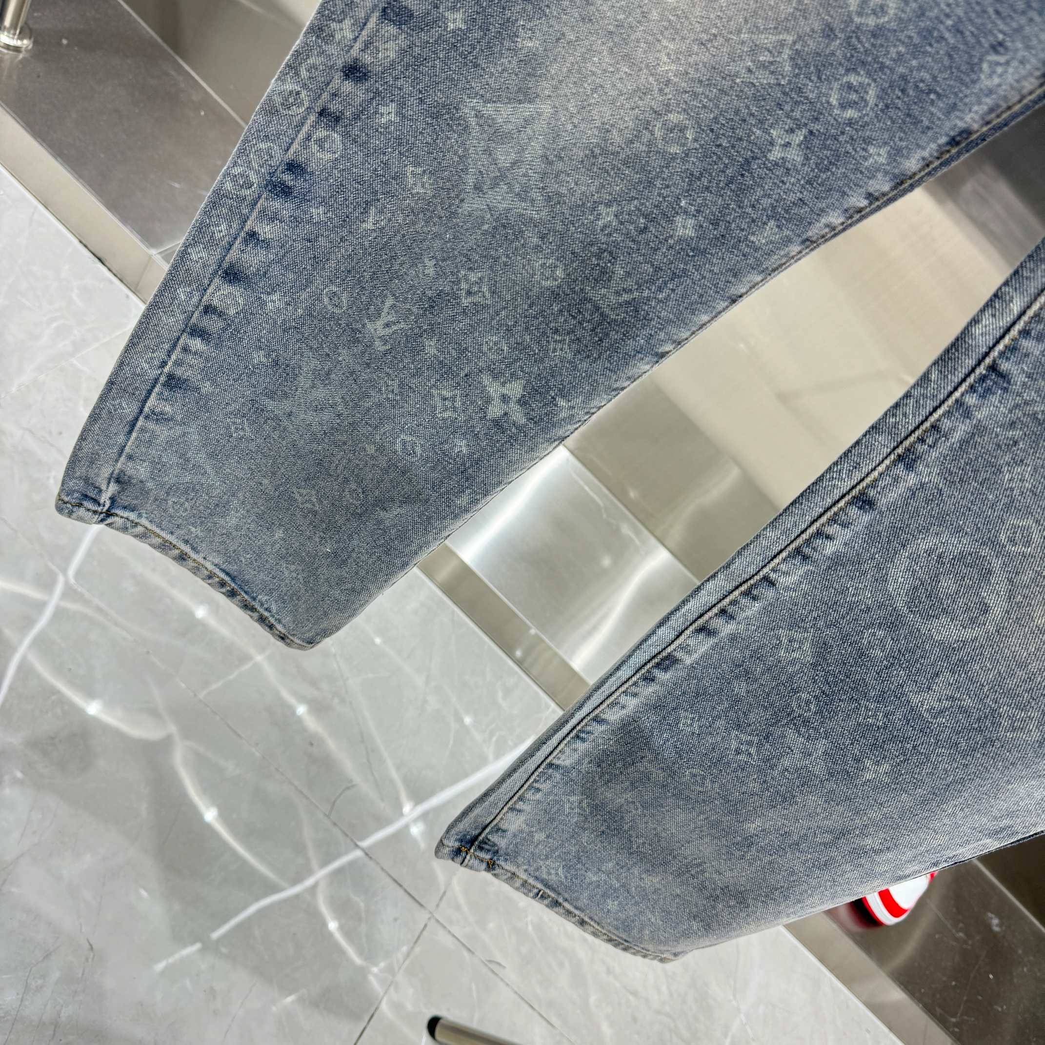 Louis Vuitton denim hem close-up, light blue monogram print stitching